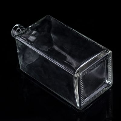 Impresión en pantalla Botella de vidrio transparente de 1000 ml para vodka de forma cuadrada con tapa de tornillo