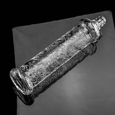 Hermosa botella de vidrio en relieve de dragón con tapa dorada logotipo personalizado y base de vidrio